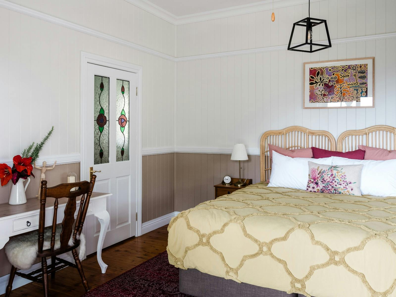 Cockatoo Suite interior with the bed, reading table and art Cockatoo Suite interior with the bed, reading table and art