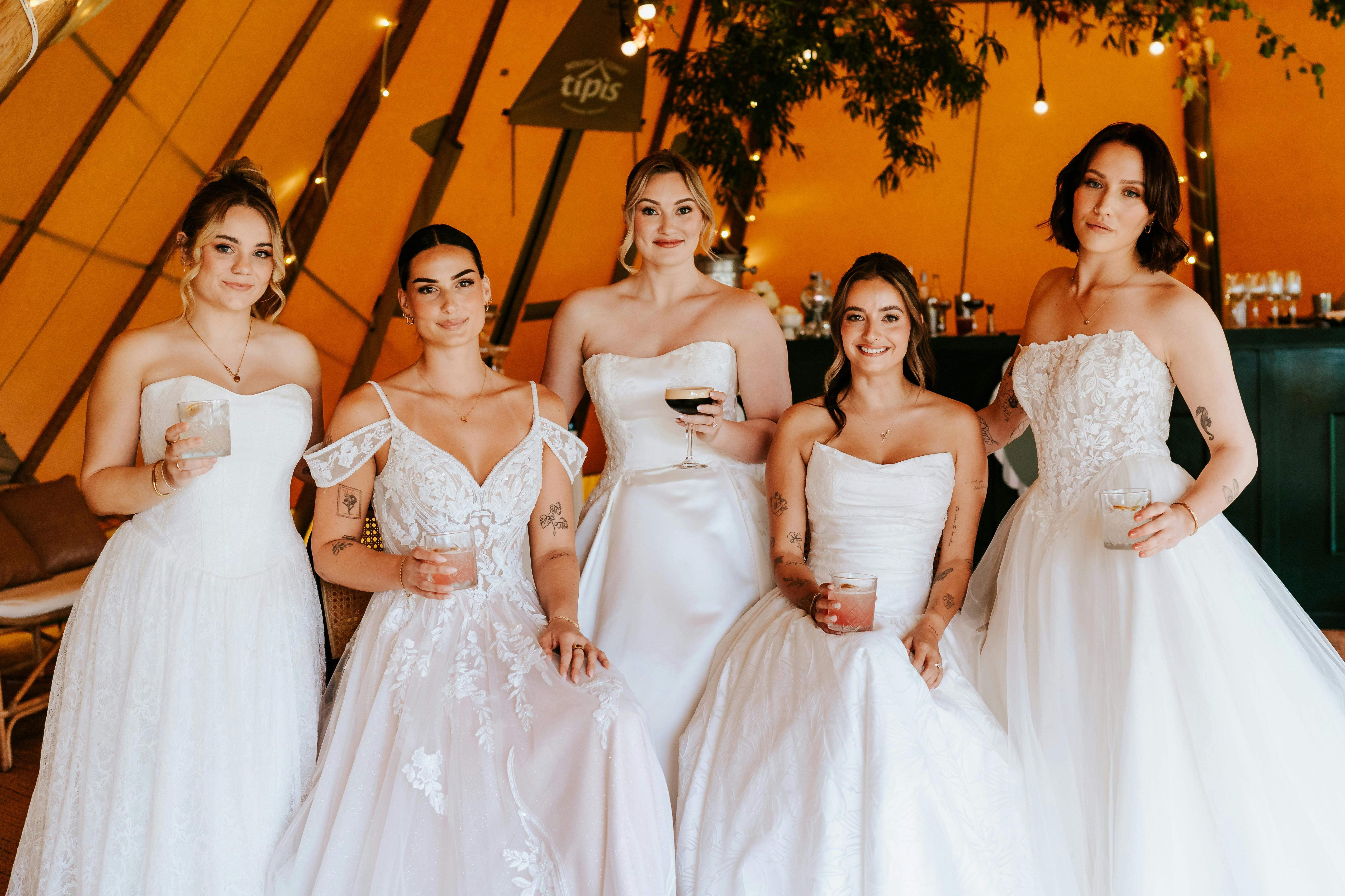 Brides having a cocktail at the bar