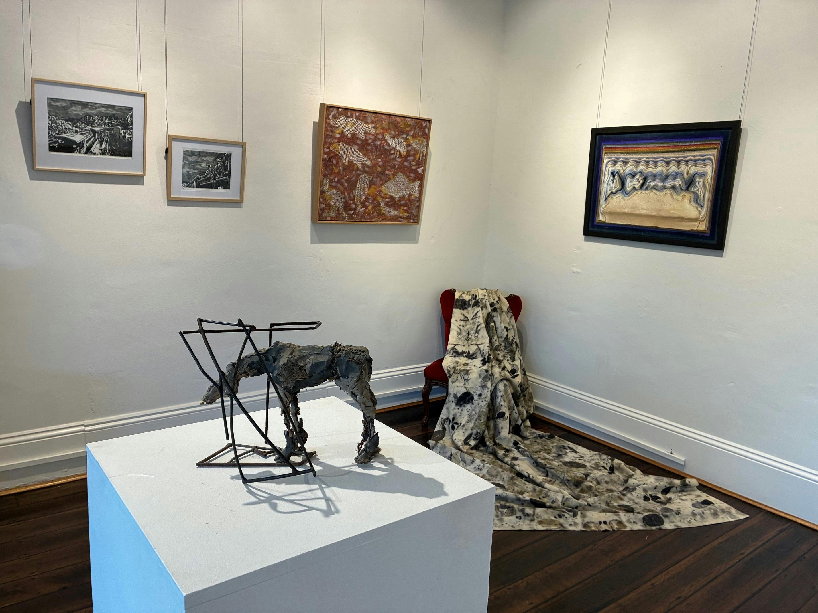 Artworks on walls and plinths in a room