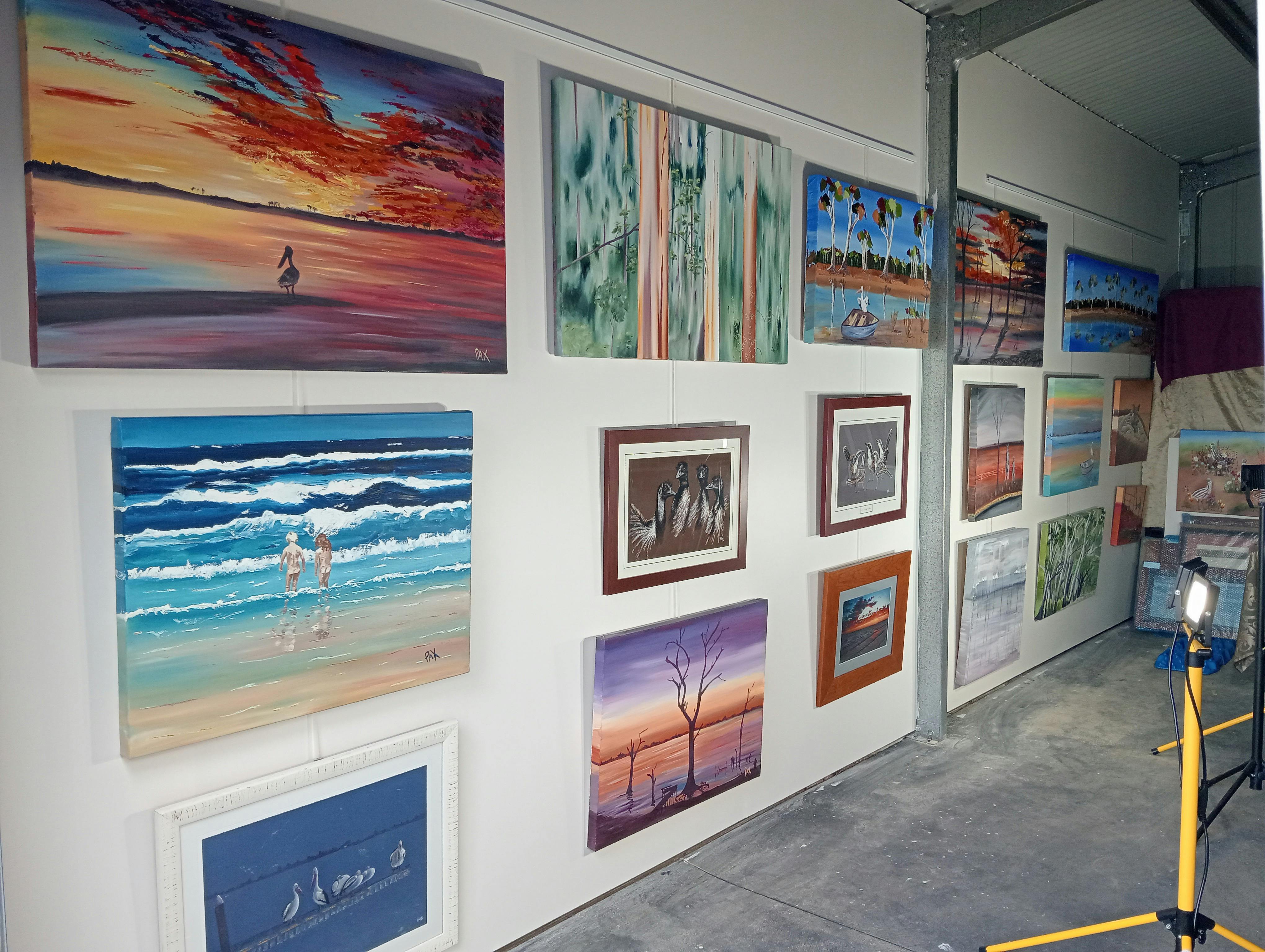 Inside Pax Art Studio Gallery: Gallery wall Paintings hanging on a wall