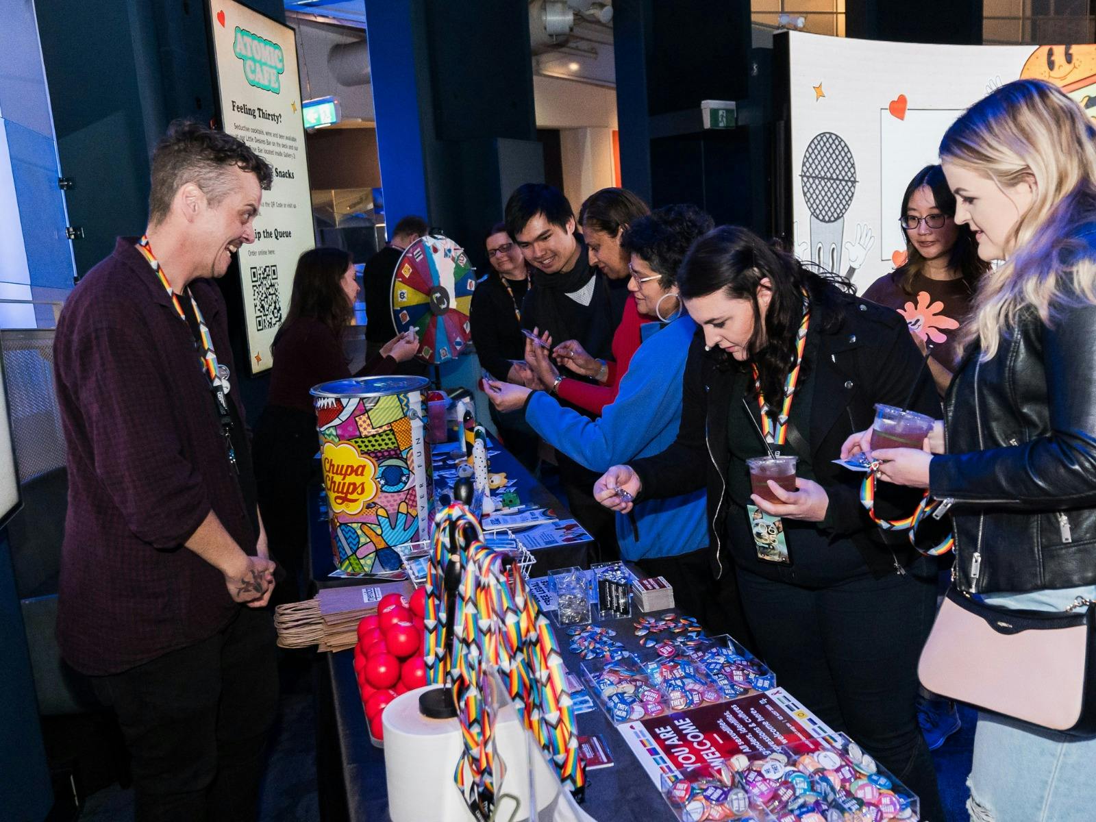 Adults choosing prizes after playing sexual health trivia with Meridian
