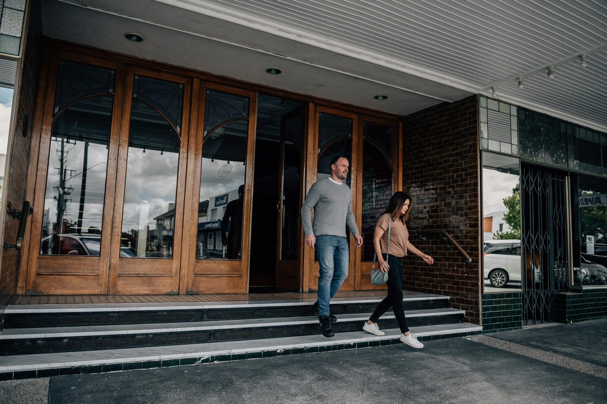 a man and a woman walking down the stairs outside the Yarram Regent Theatre