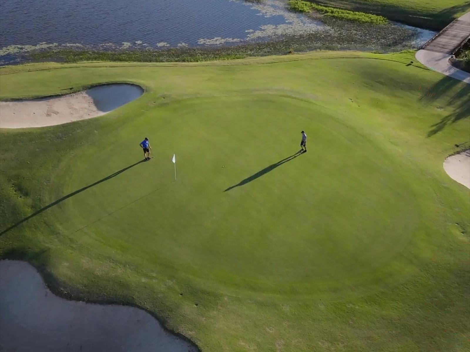 Drone image of the green at pelican waters golf club Drone image of the green at pelican waters golf club