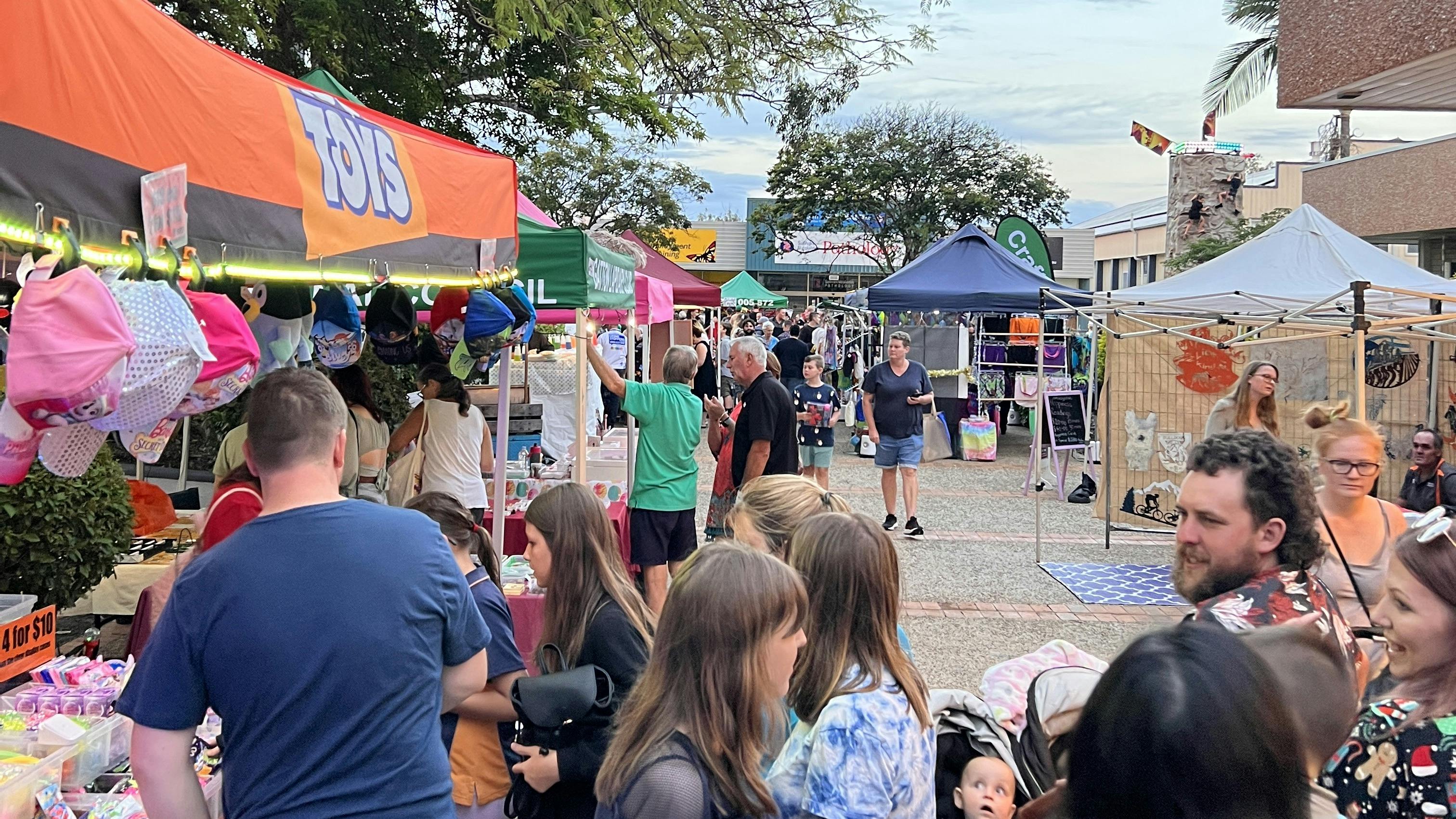 Market stalls with people buying product