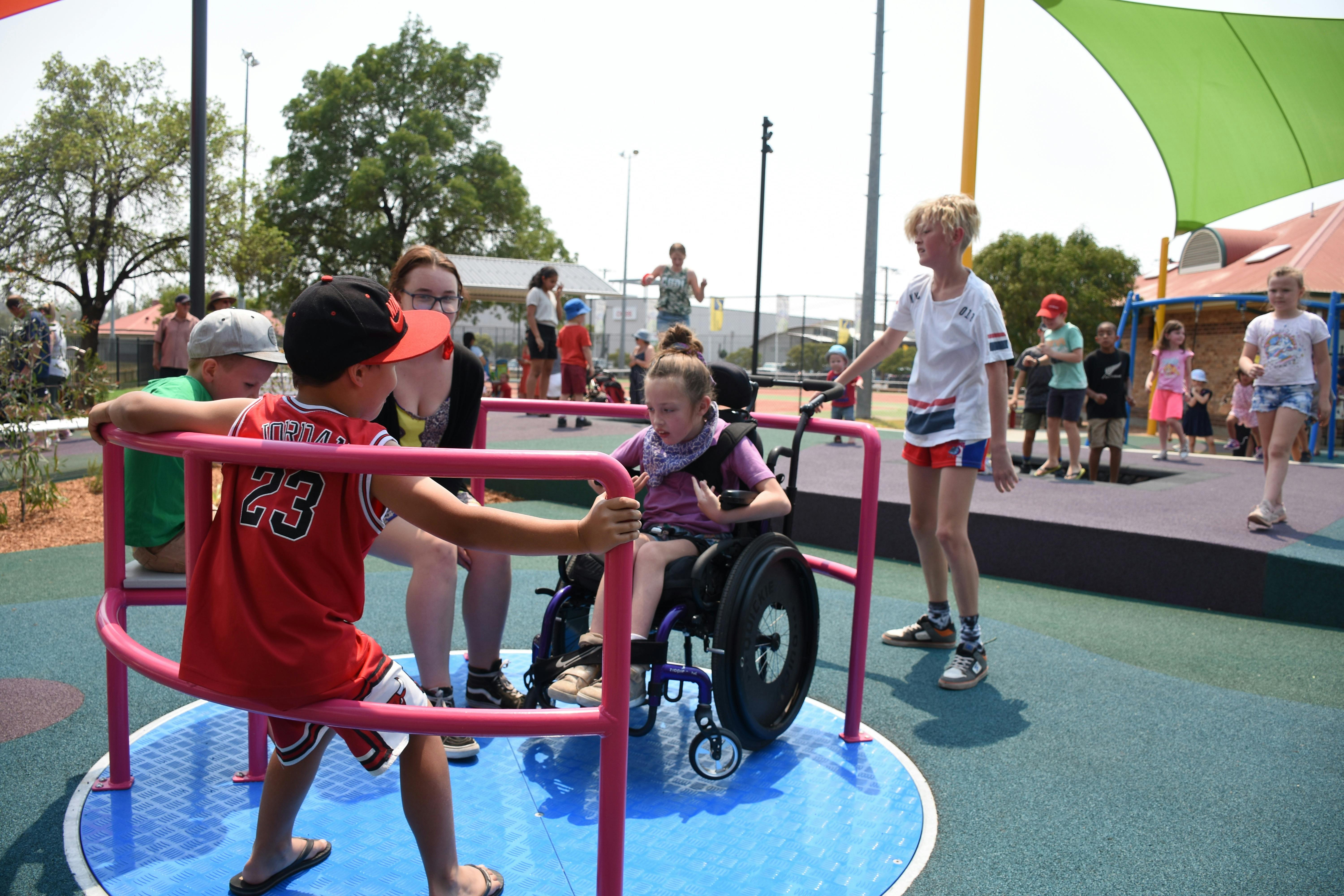 kids on play equipment incl. wheel chair