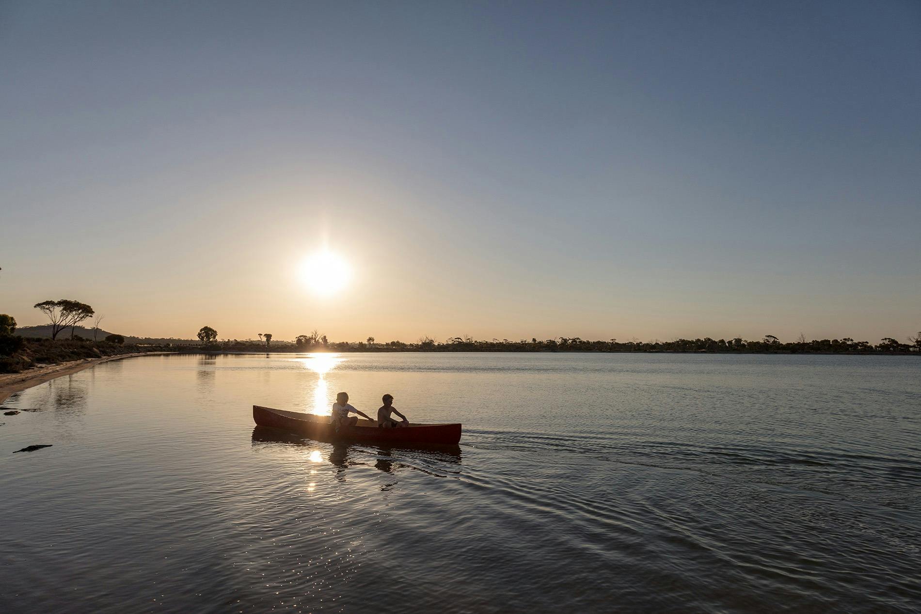 Young boys kayaking on Lake Magic at sunset, near Hyden