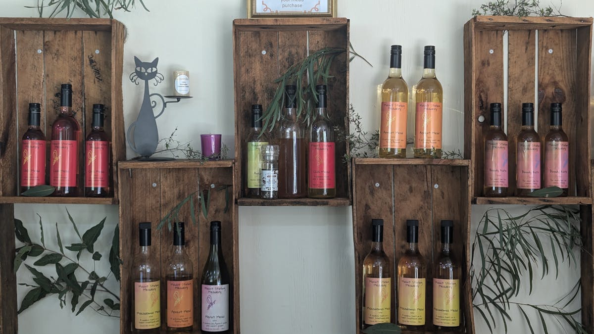 Recycled fruit boxes mounted  on wall display Macadamia, Apricot and Chill meads.