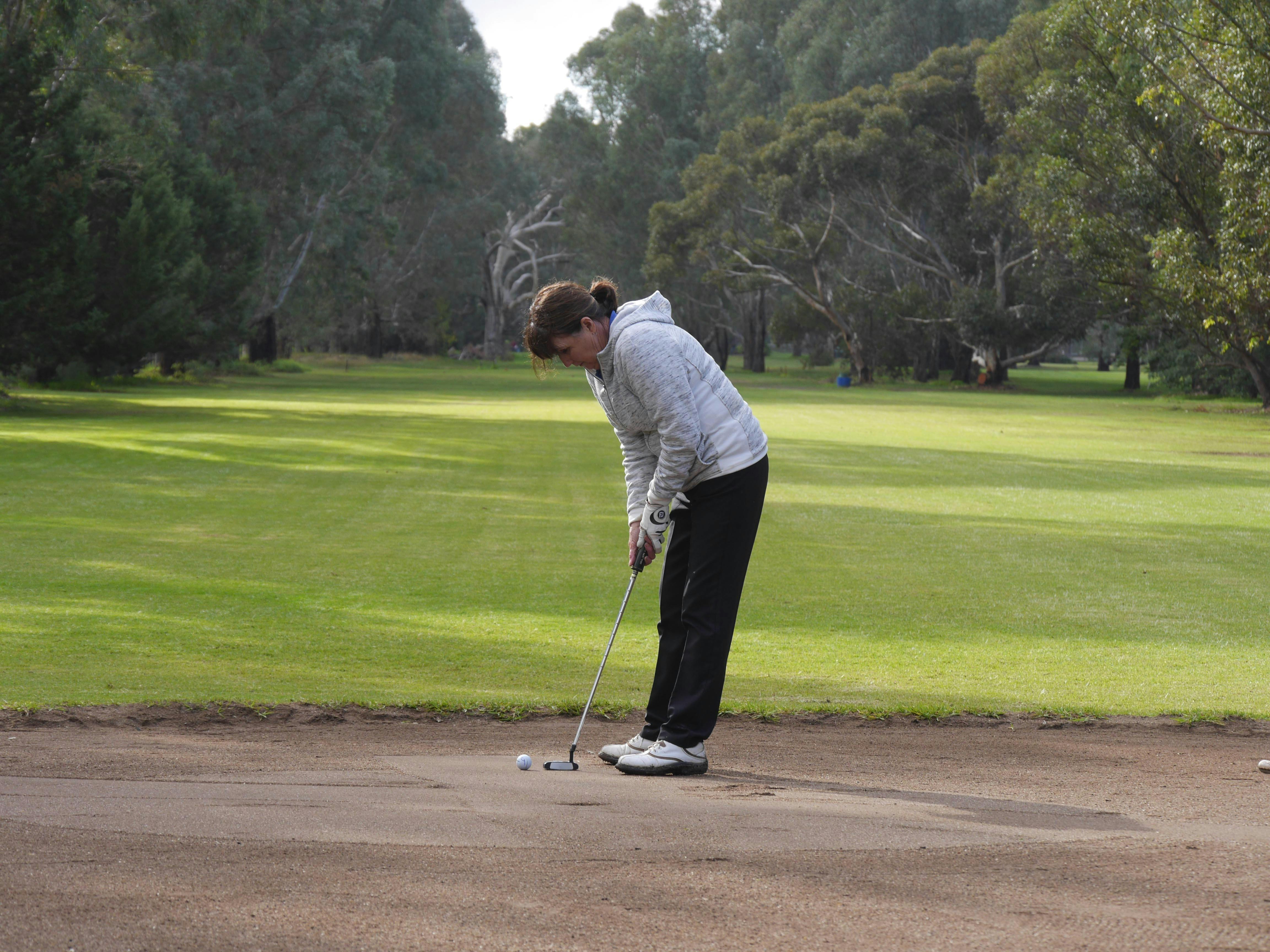 Player putting on sand green