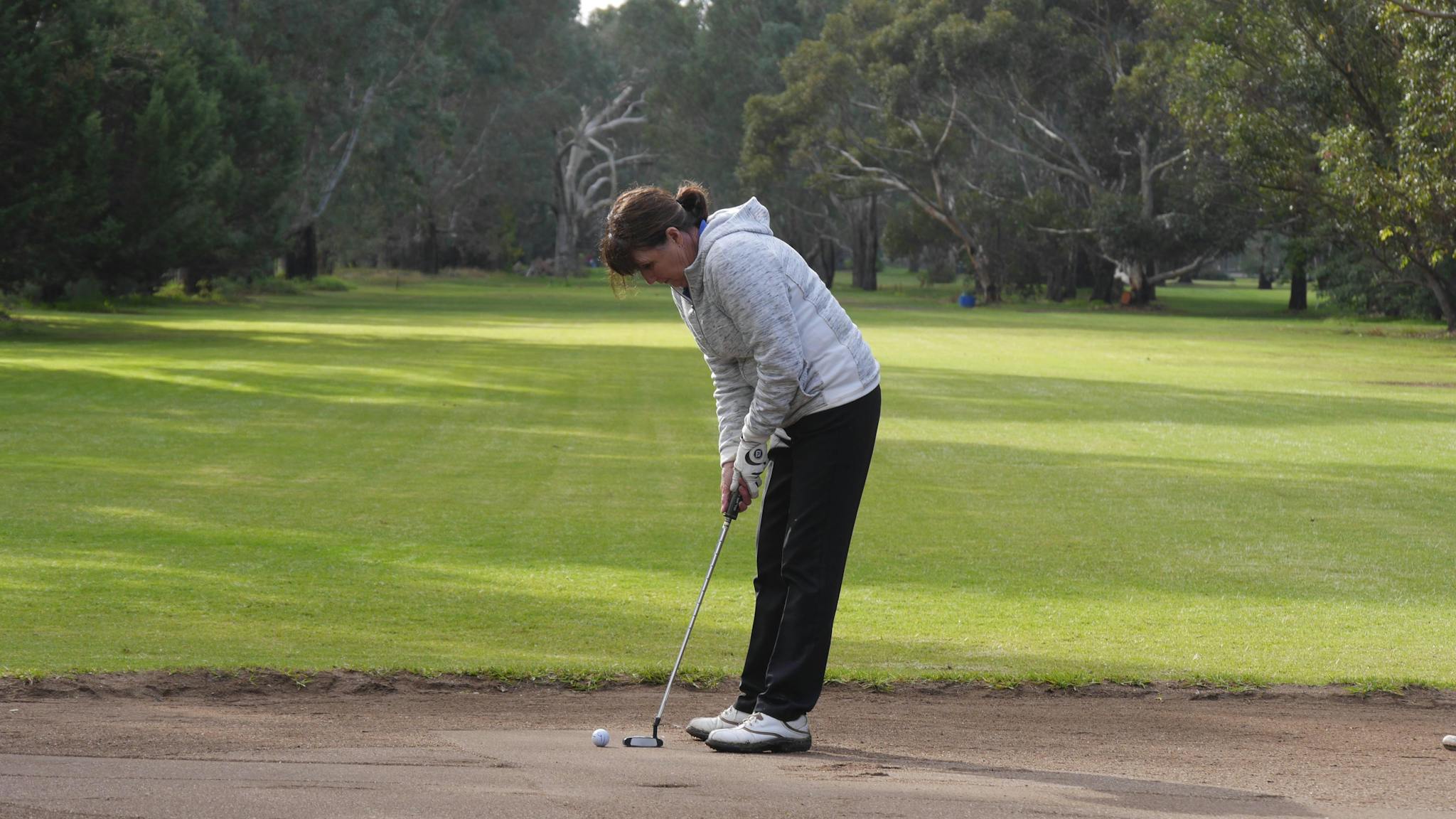 Player putting on sand green