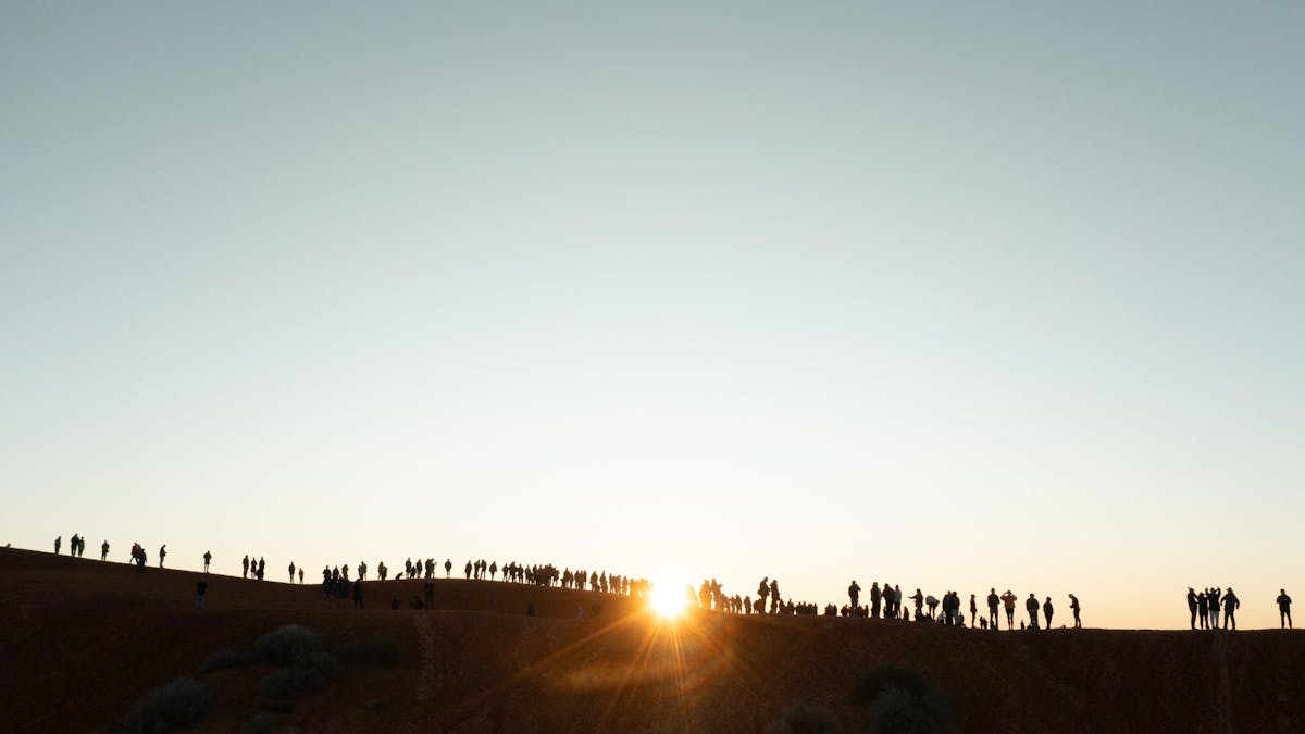Sunrise over the Simpson Desert with the Big Red Bash campground and red sand dunes, Birdsville Quee