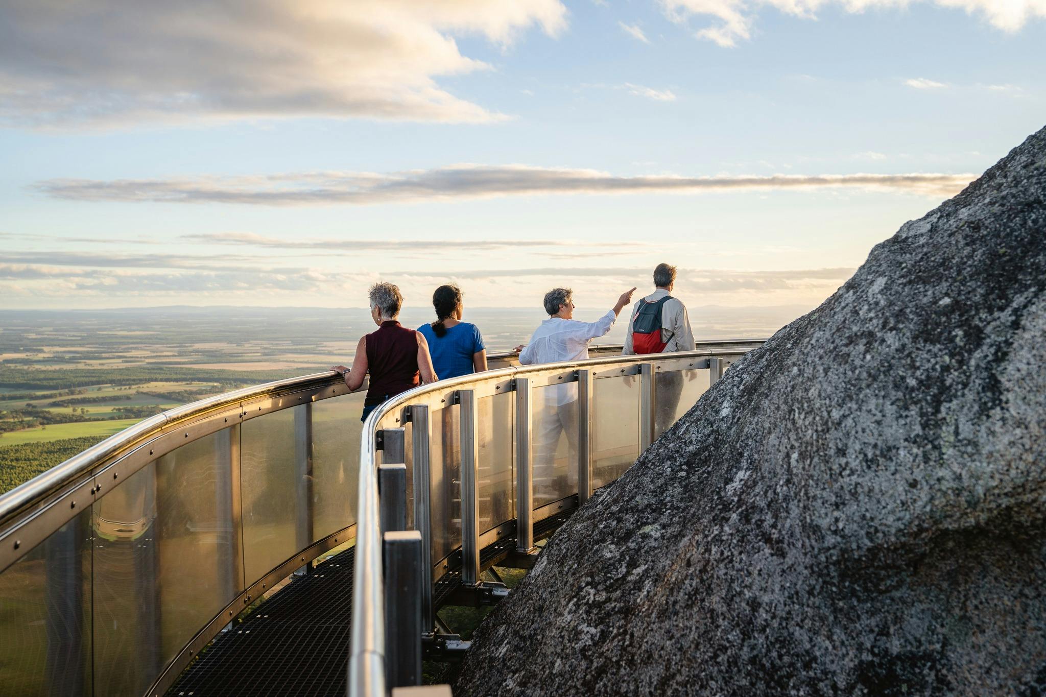 four people on catwalk on granite hill