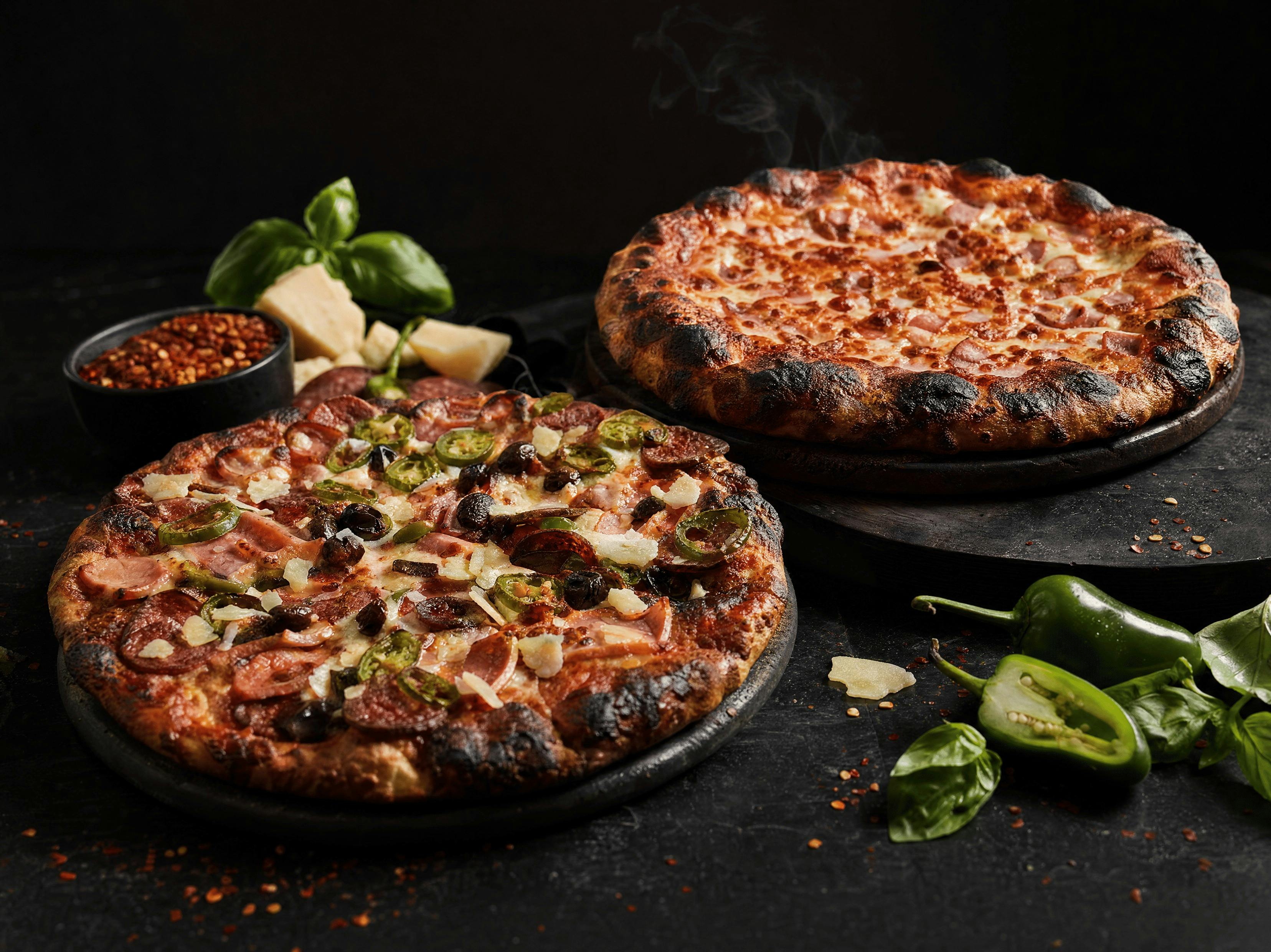 Two Italian pizzas At medici fresh out the oven