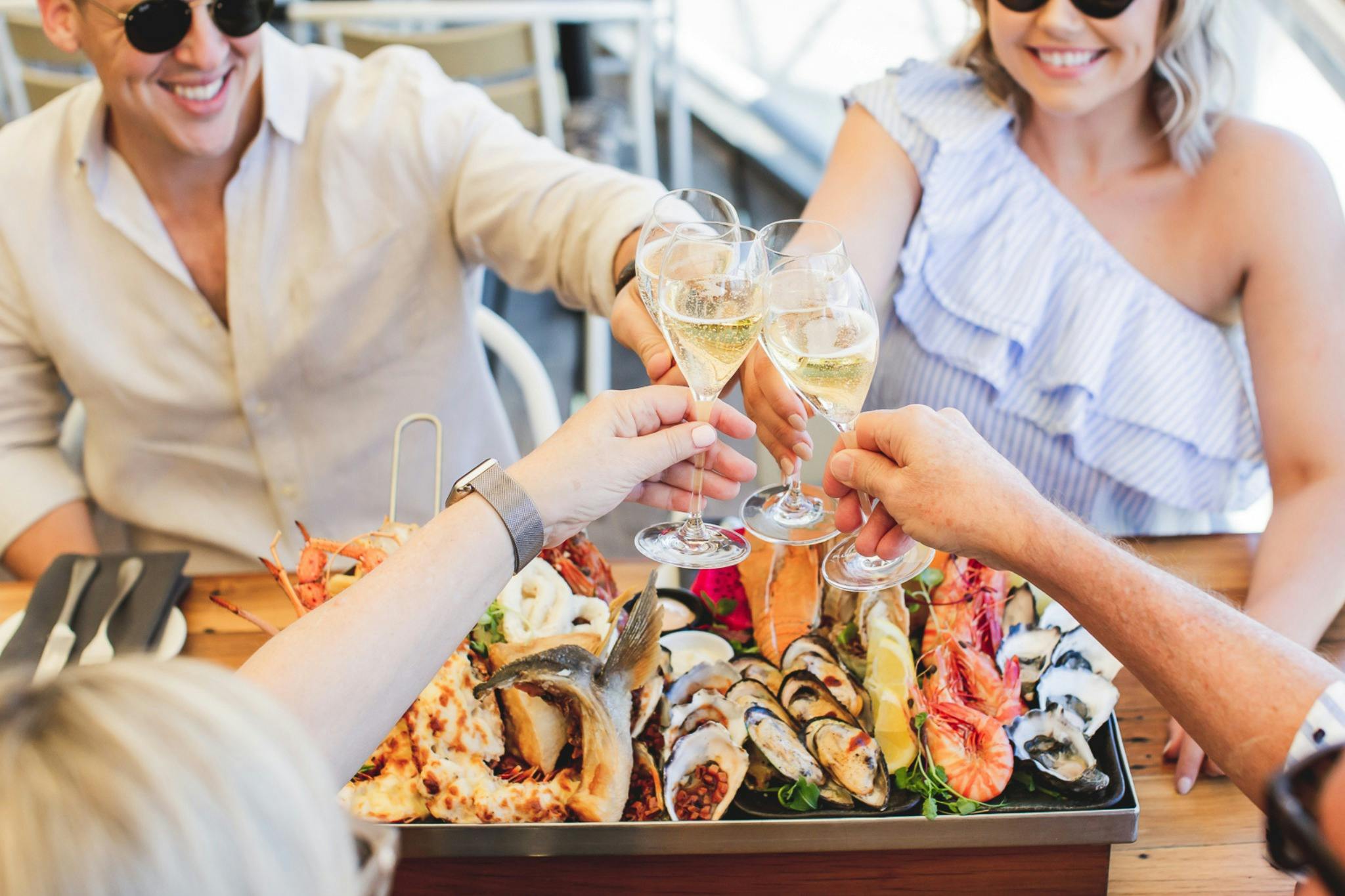 Tempest Restaurant	Guests toasting sparkling wine over a seafood at Tempest Restaurant