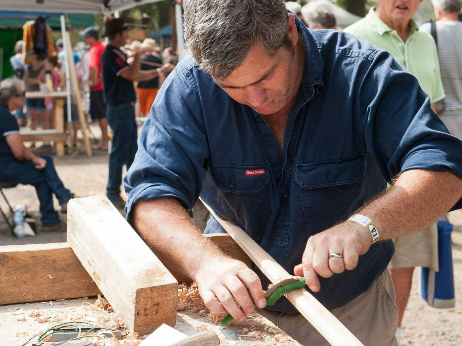 Robert Geddes carving timber to make a long bow