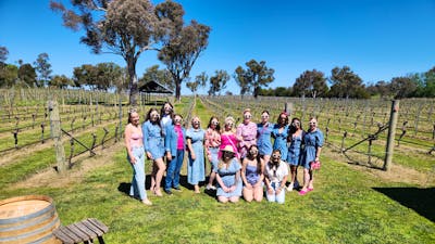 A diverse group of people standing together, smiling and posing for a photo.