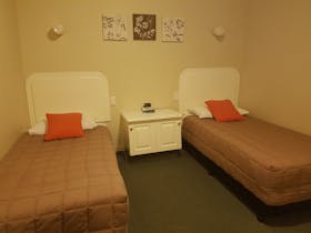 Two single beds with bedside table between the beds