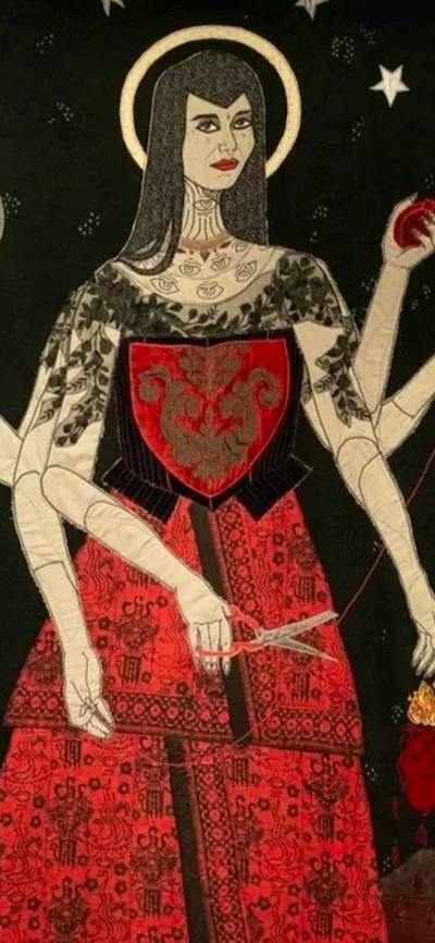 Image of a textile artwork showing a woman standing in a red dress and six arms