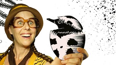 Girl with glasses holding a shadow puppet echidna hatching out of an egg