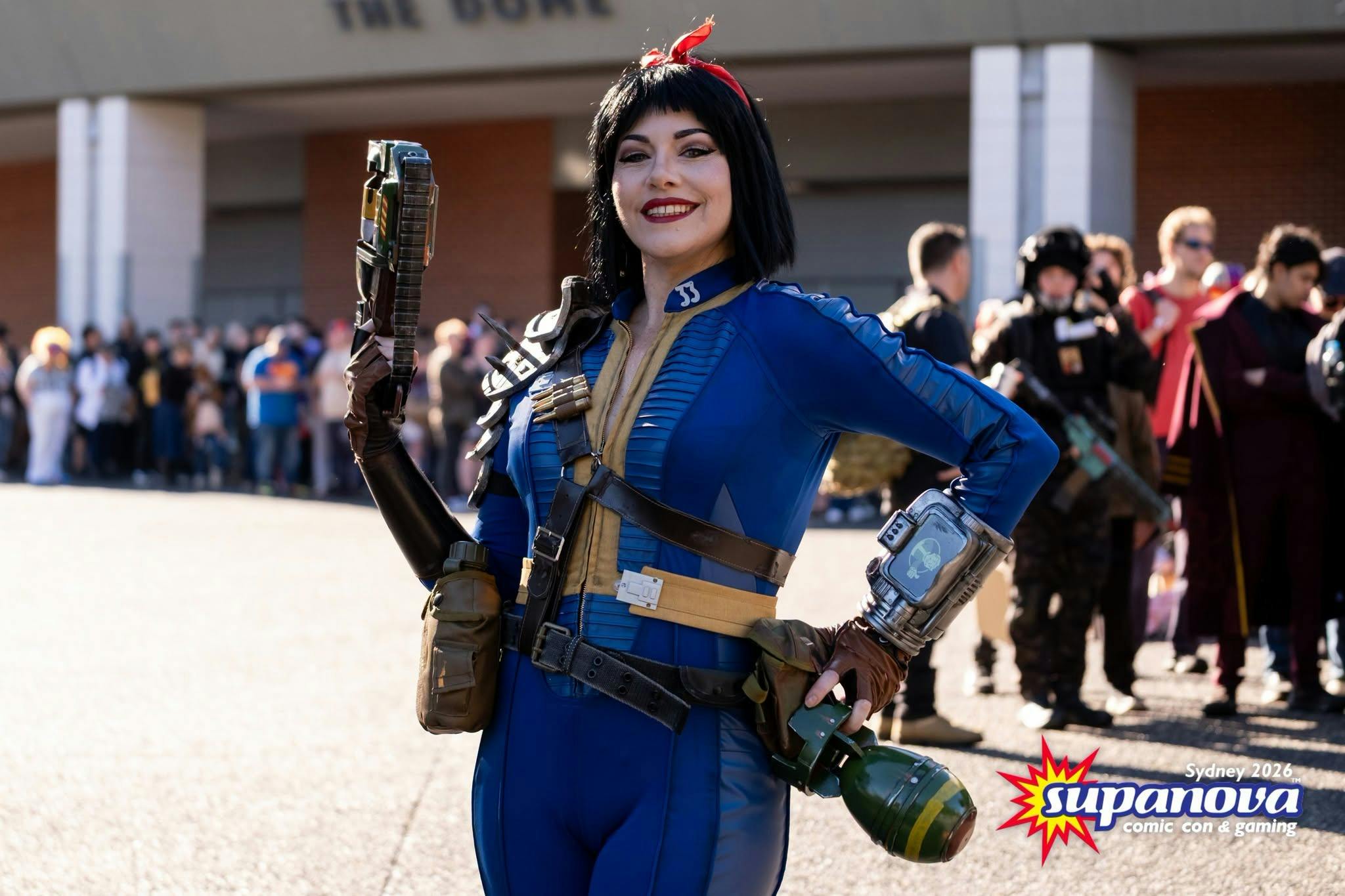 Cosplayer posing in a blue Fallout-inspired costume.