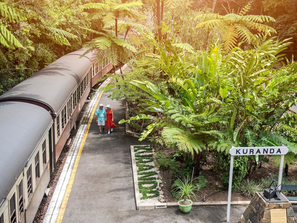 A couple walks along the platform, preparing to board the Kuranda Scenic Railway in Tropical North Q