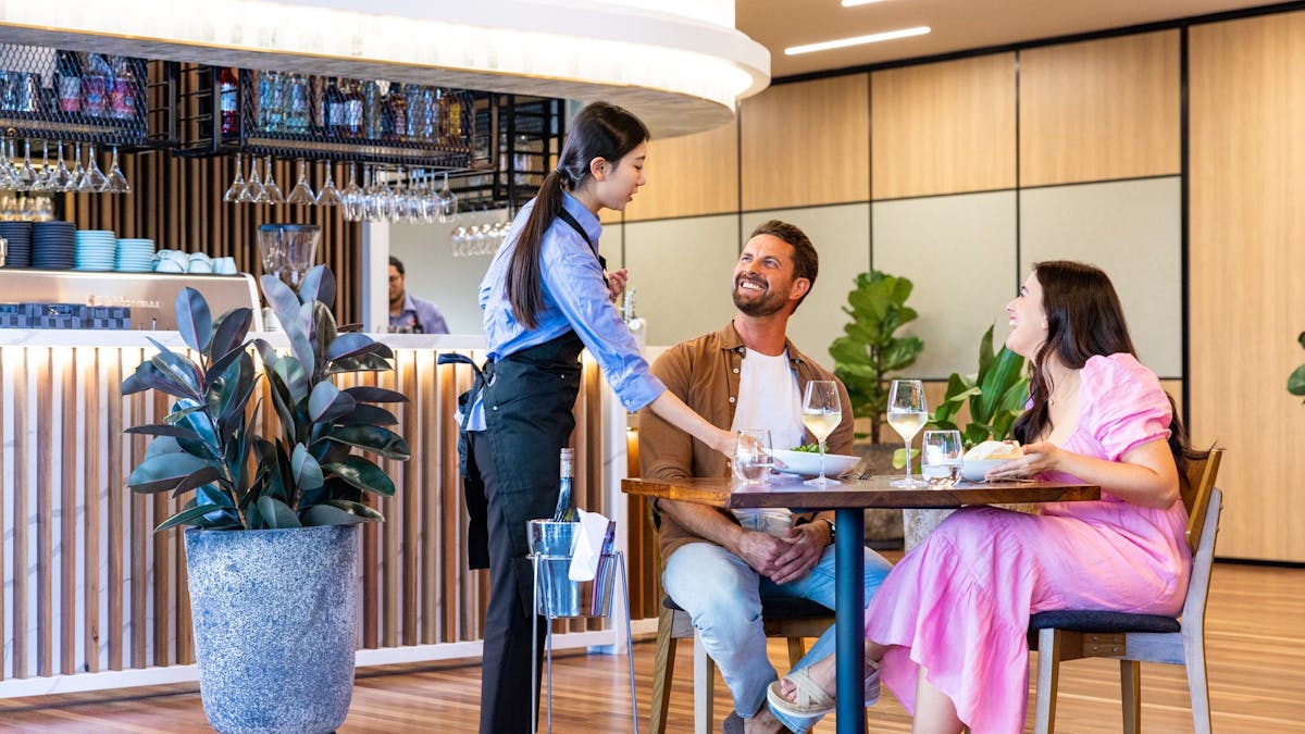 Couple enjoying enjoying dinner in restaurant being served
