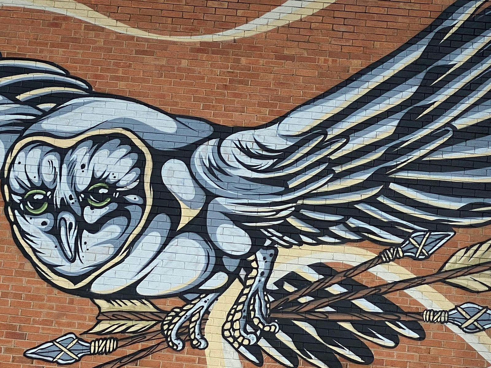 Owl street art on brick wall Owl street art on brick wall