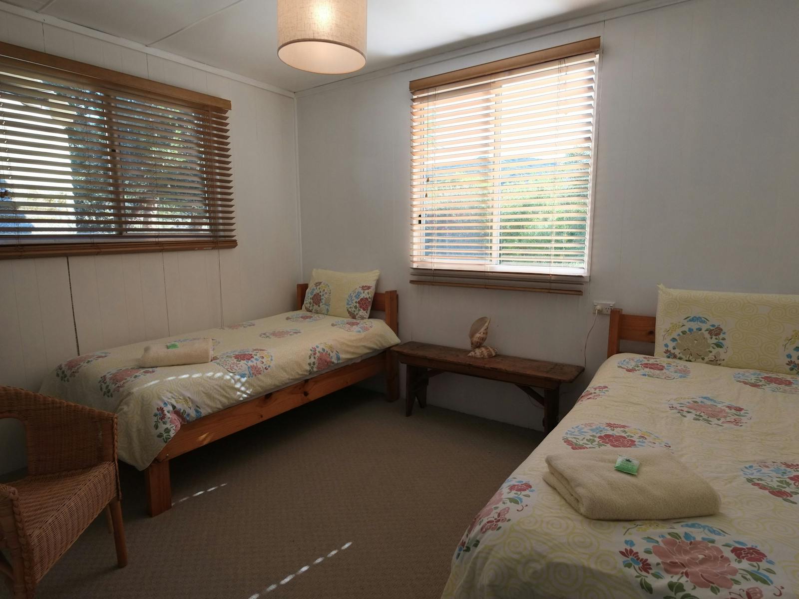 Bright sunny twin single room with wool donnas and wool blankets.