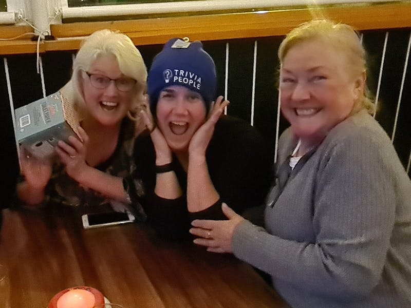 A team of three people enjoying their win at one of our trivia nights.