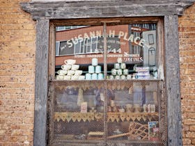 Goods in the window of the corner shop, 64 Gloucester Street, Susannah Place Museum