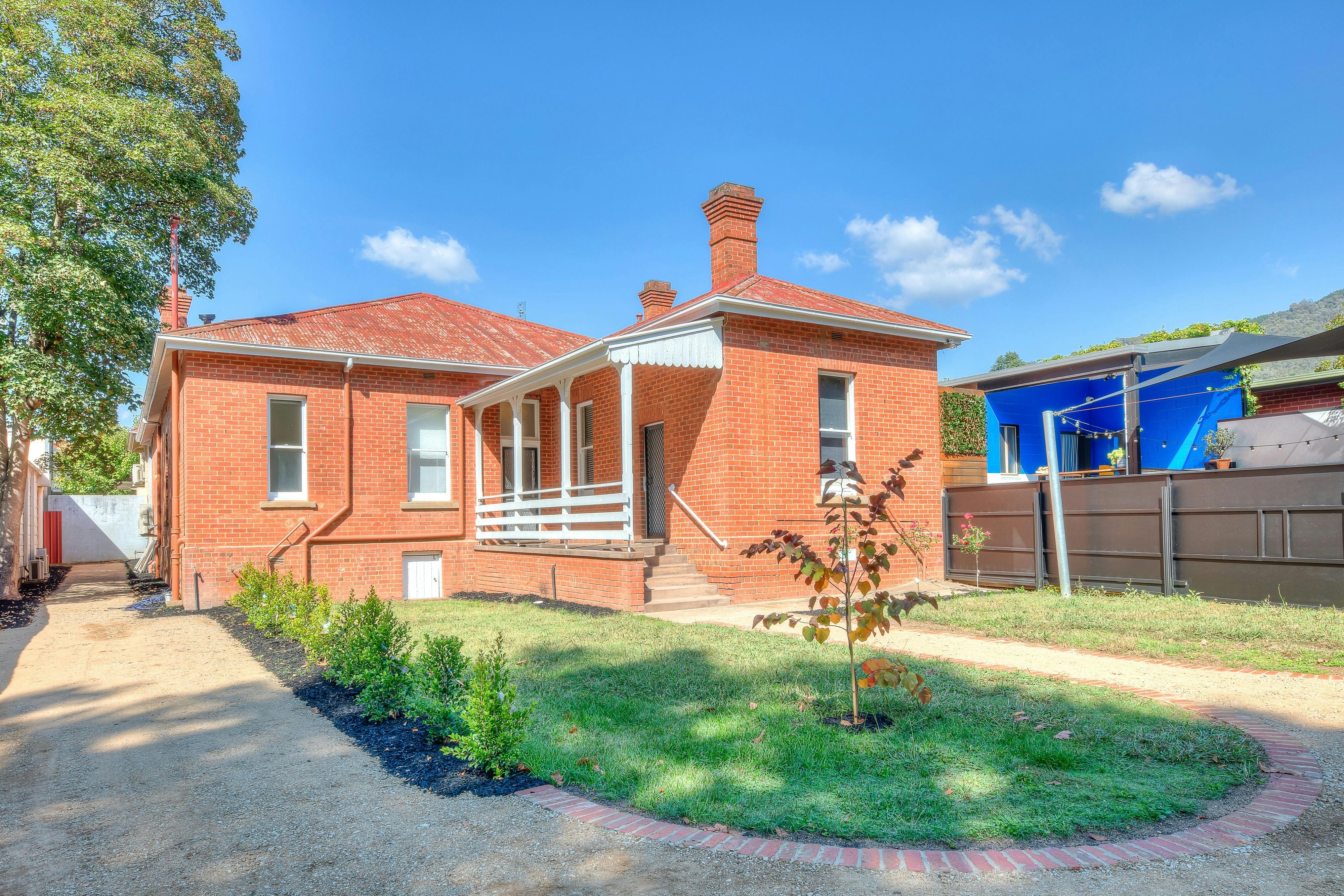 Red brick house with stairs up to main door