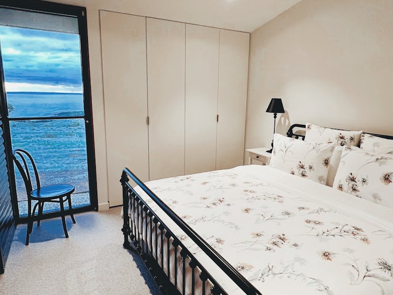 king-size bed, generous cupboard space, and beautiful views across the property toward Kangaroo Isla