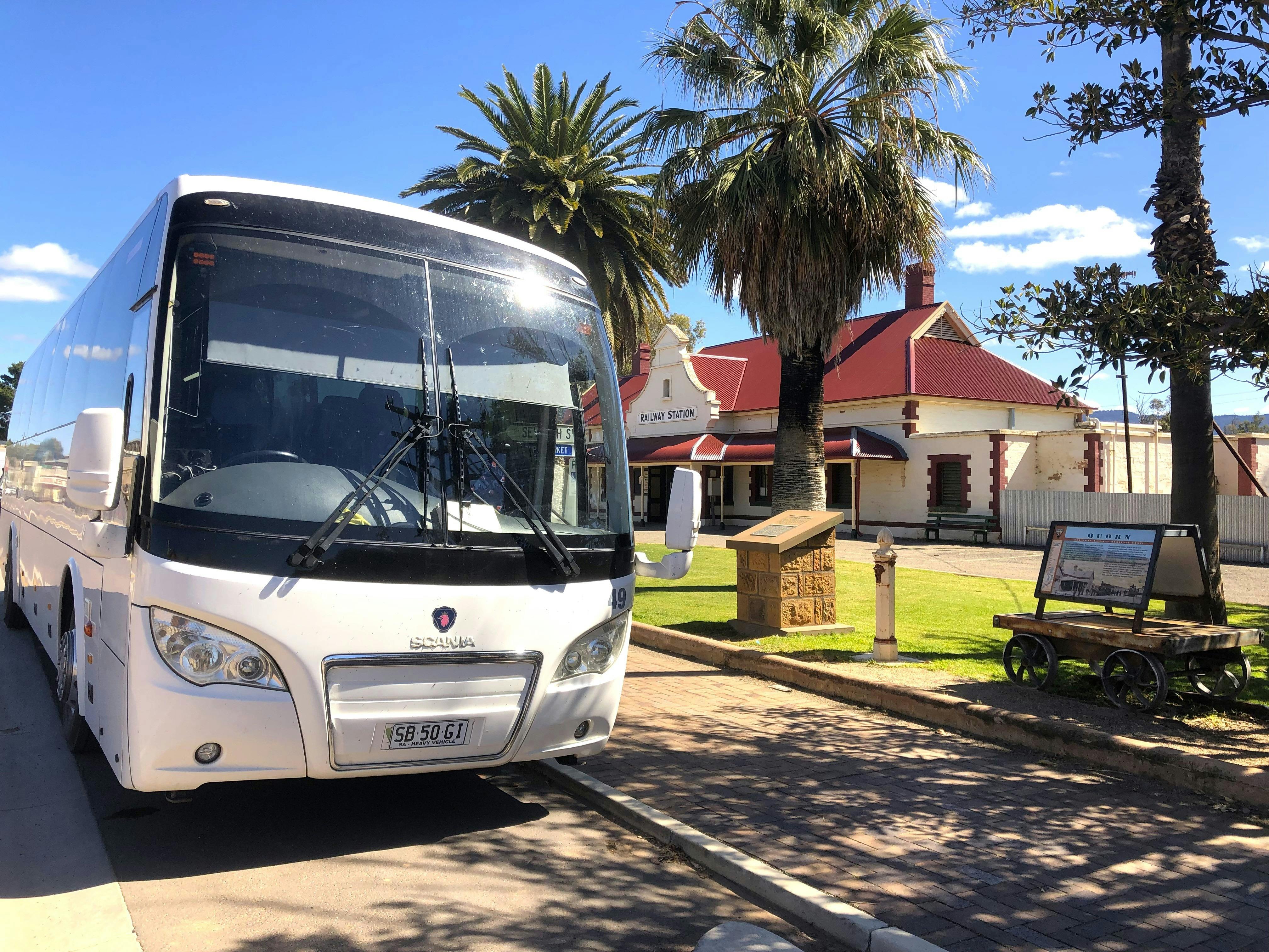 Large coach in front of historic building