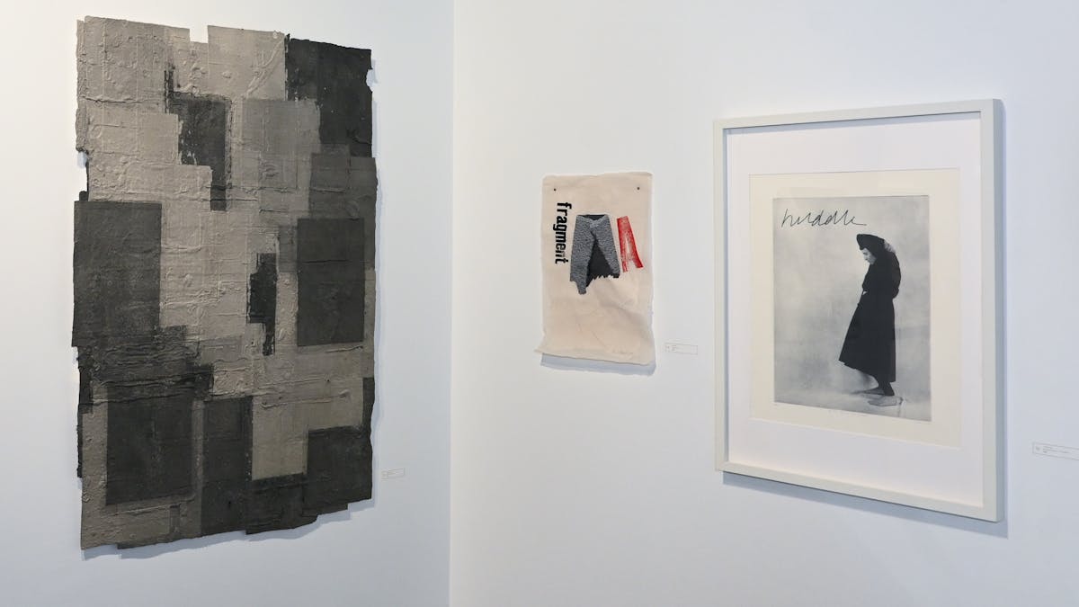 Three artworks displayed on the gallery wall