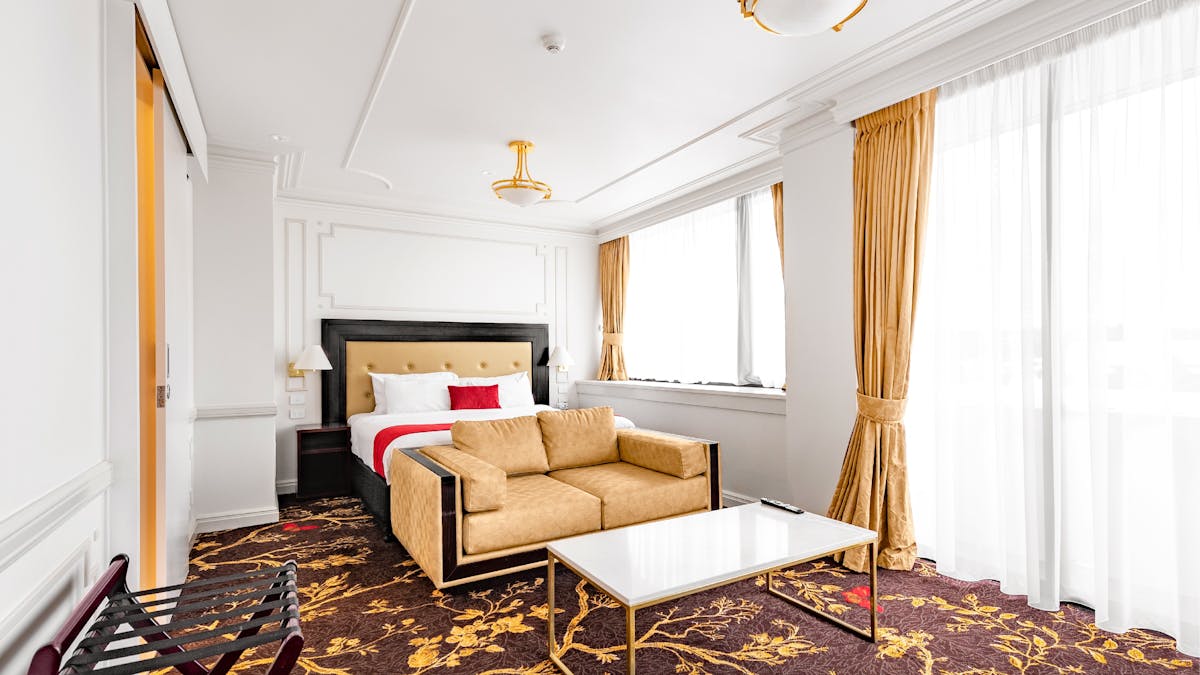Luxury King Suite bedroom featuring the bed, couch and table