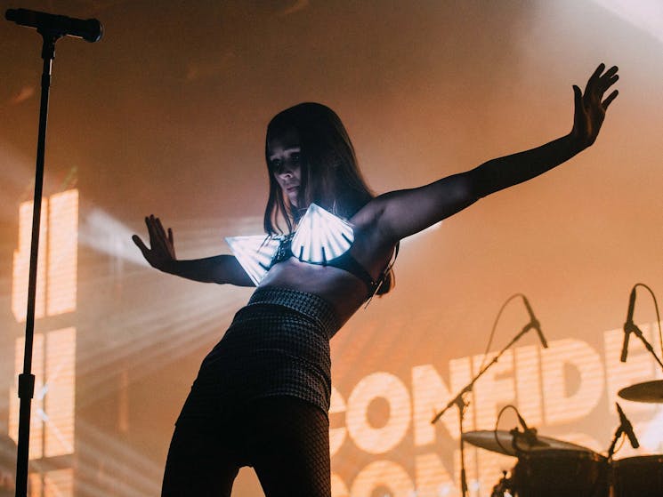 Confidence Man performing with light up bra