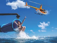 Girl sliding down the only waterslide on the Great Barrier Reef (Moore Reef), with a Zoom Helicopter