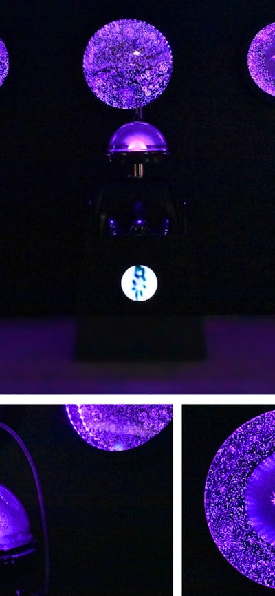 Purple abstract lights being displayed from four different spheres.