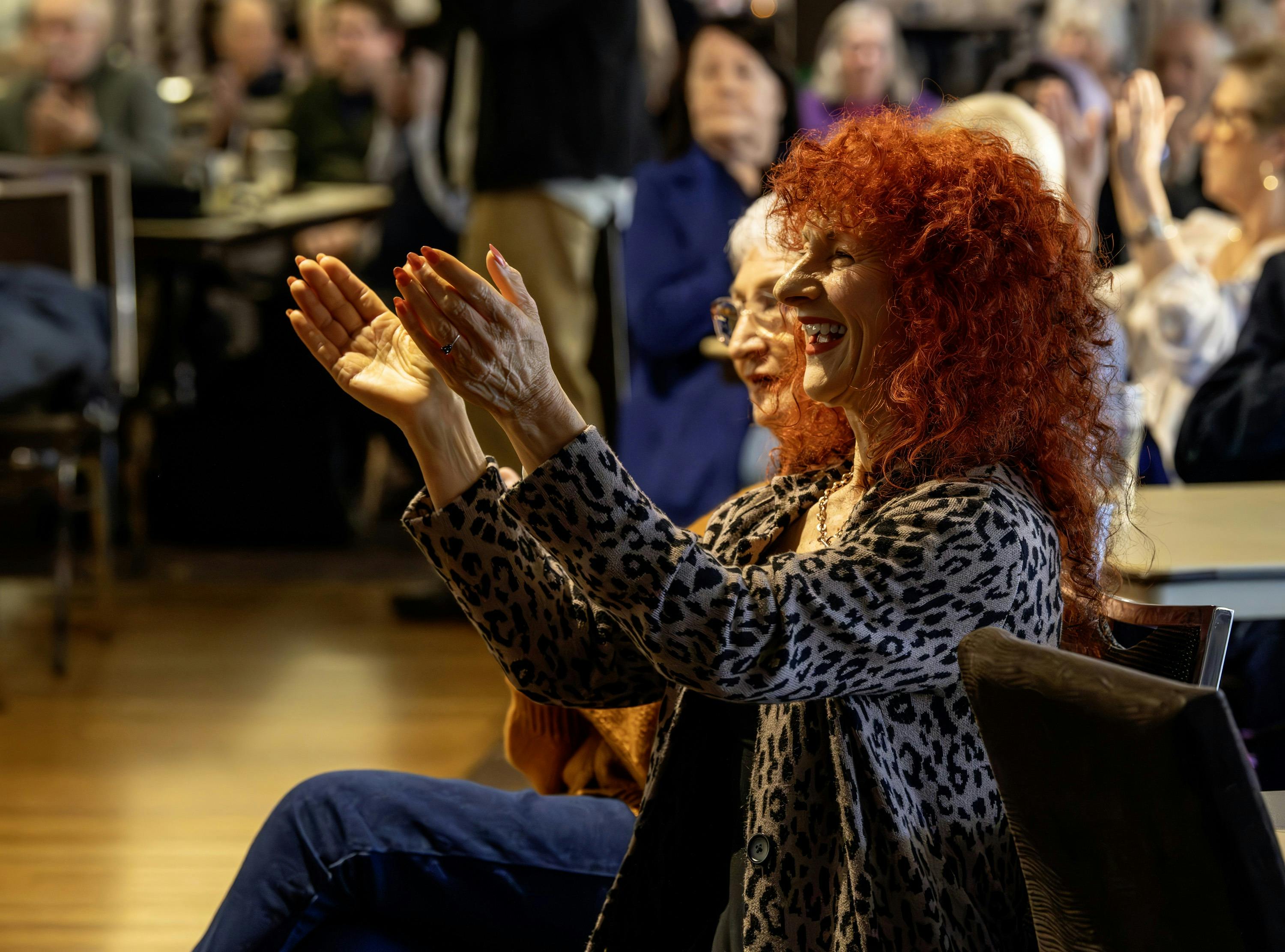 Two women of different ages enjoying a performance.