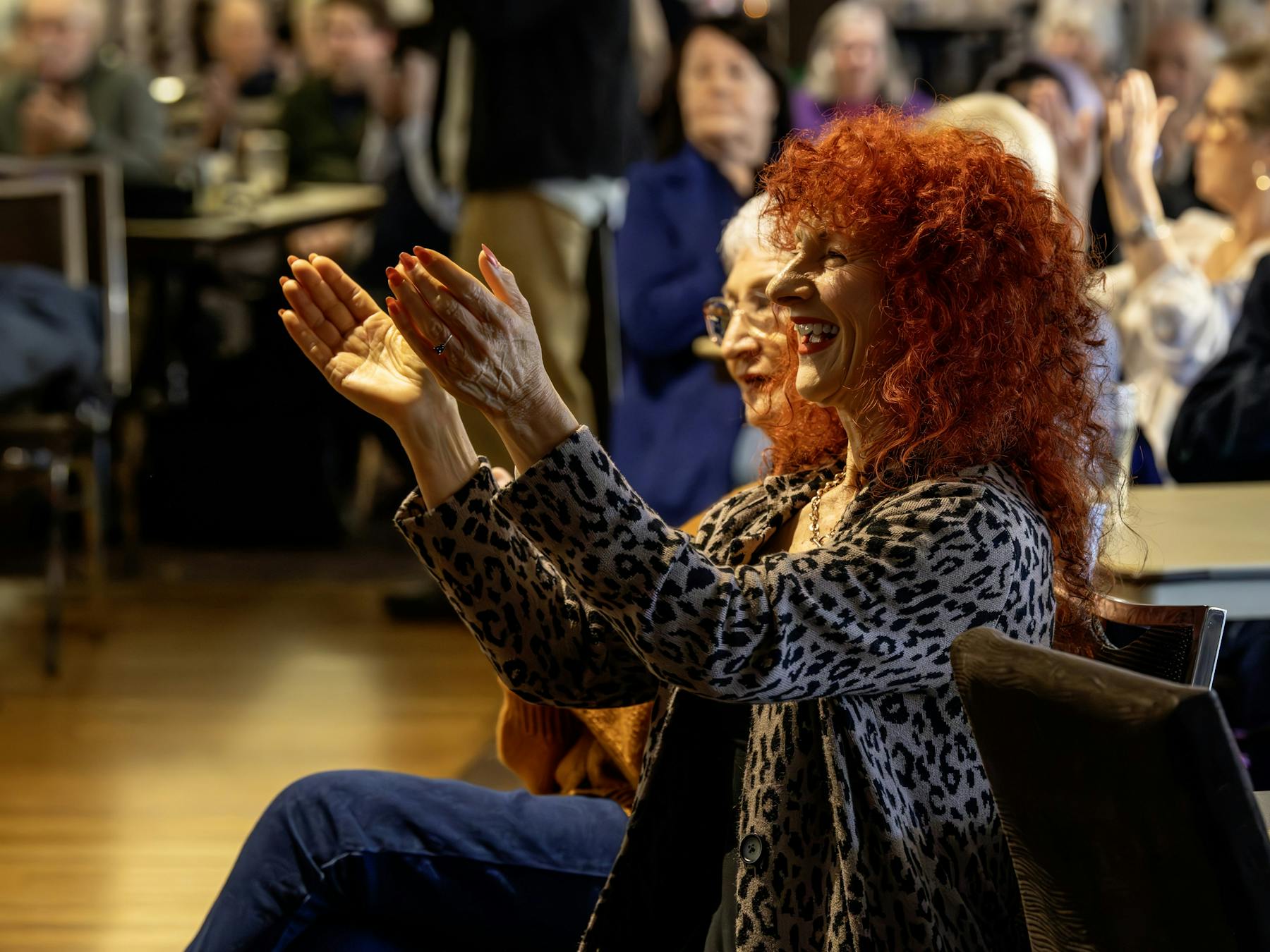 Two women of different ages enjoying a performance.