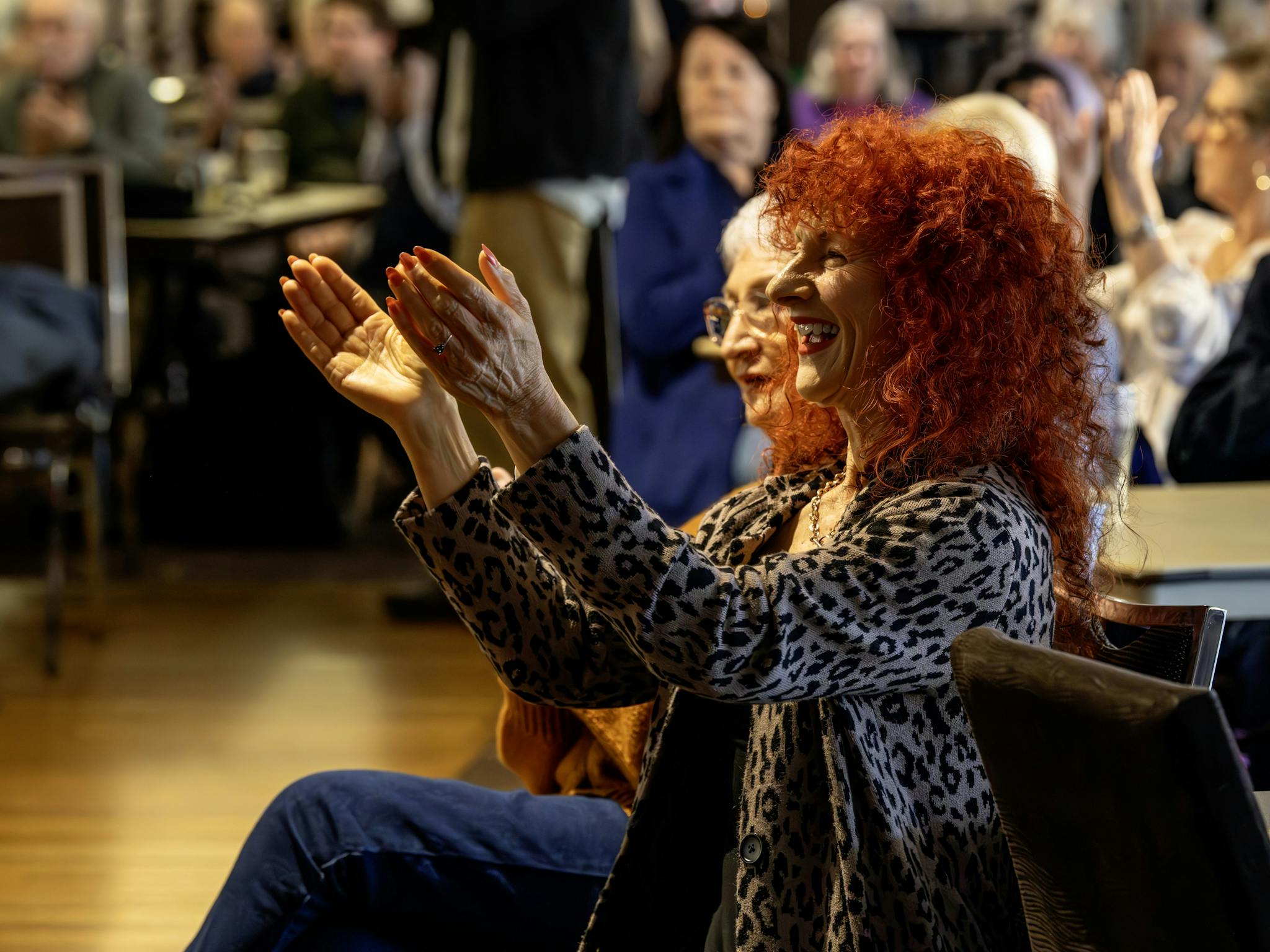 Two women of different ages enjoying a performance.