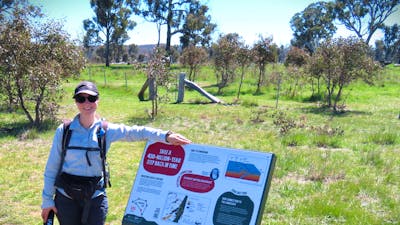 Woman standing beside informative sign