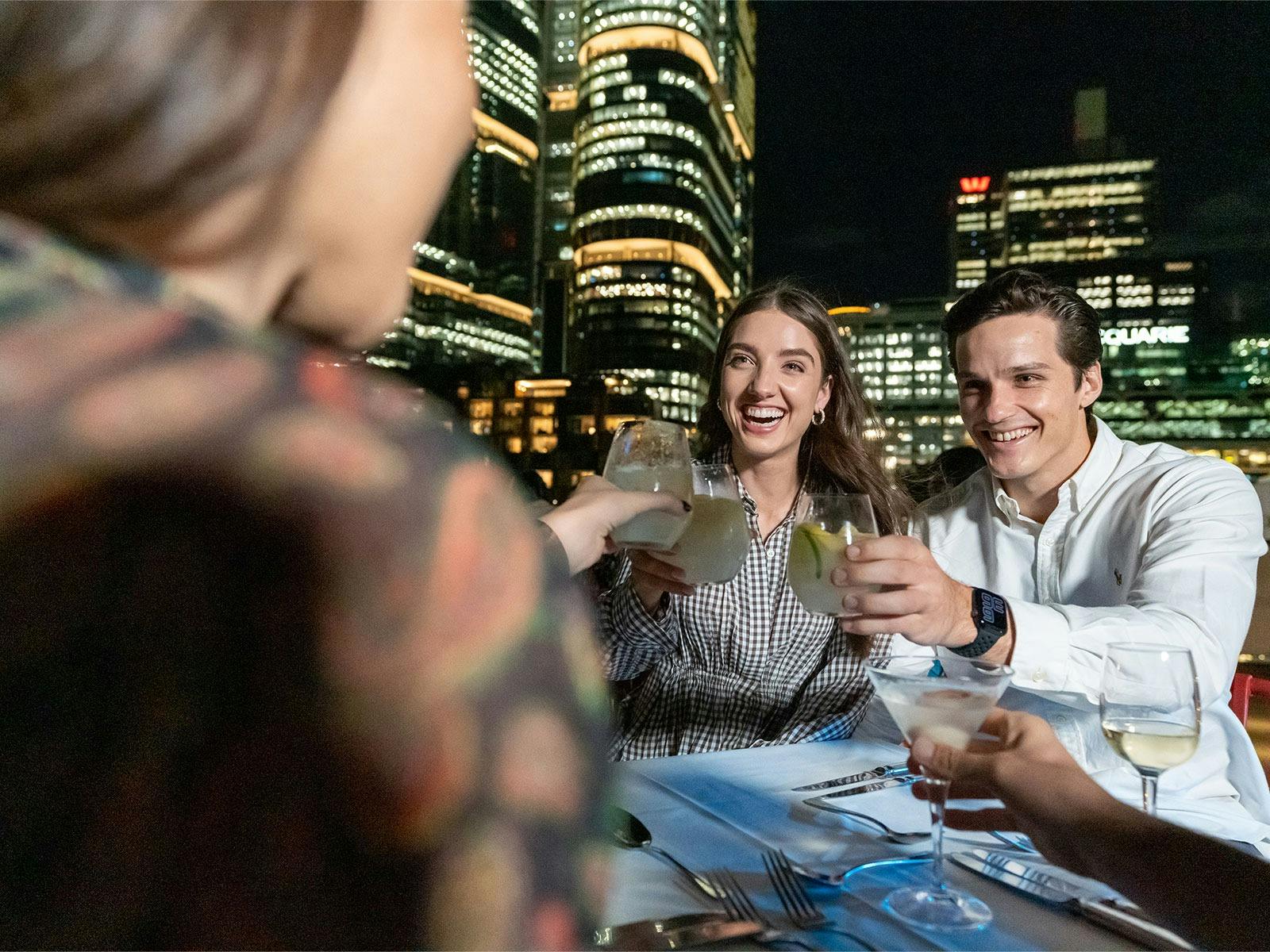 Guests toasting to the holiday season on a Christmas party cruise in Sydney