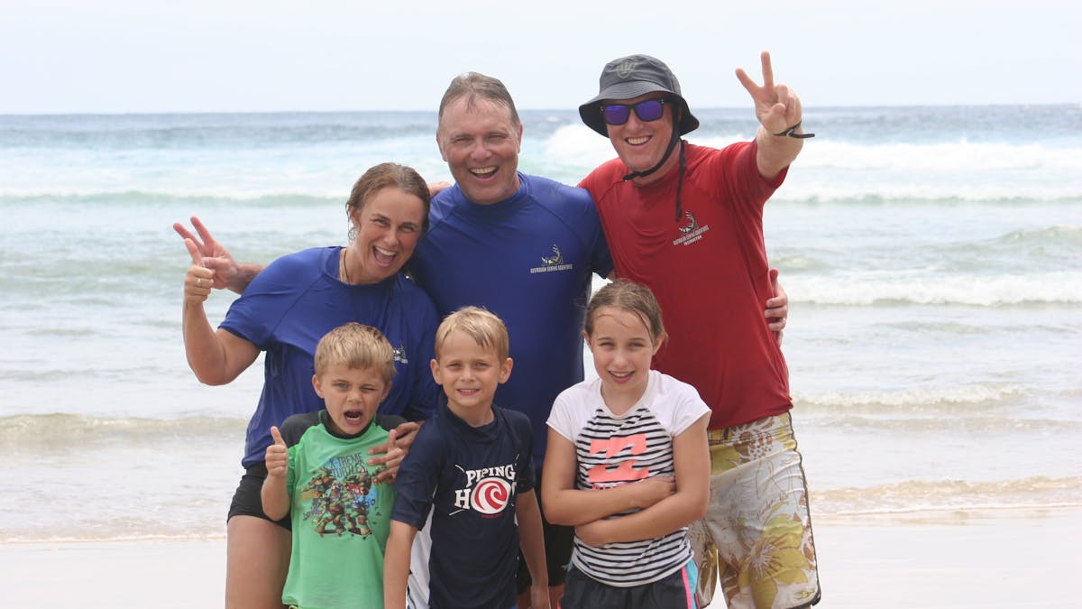 A family celebrates an unforgettable beach day after their surf adventure on the Gold Coast.