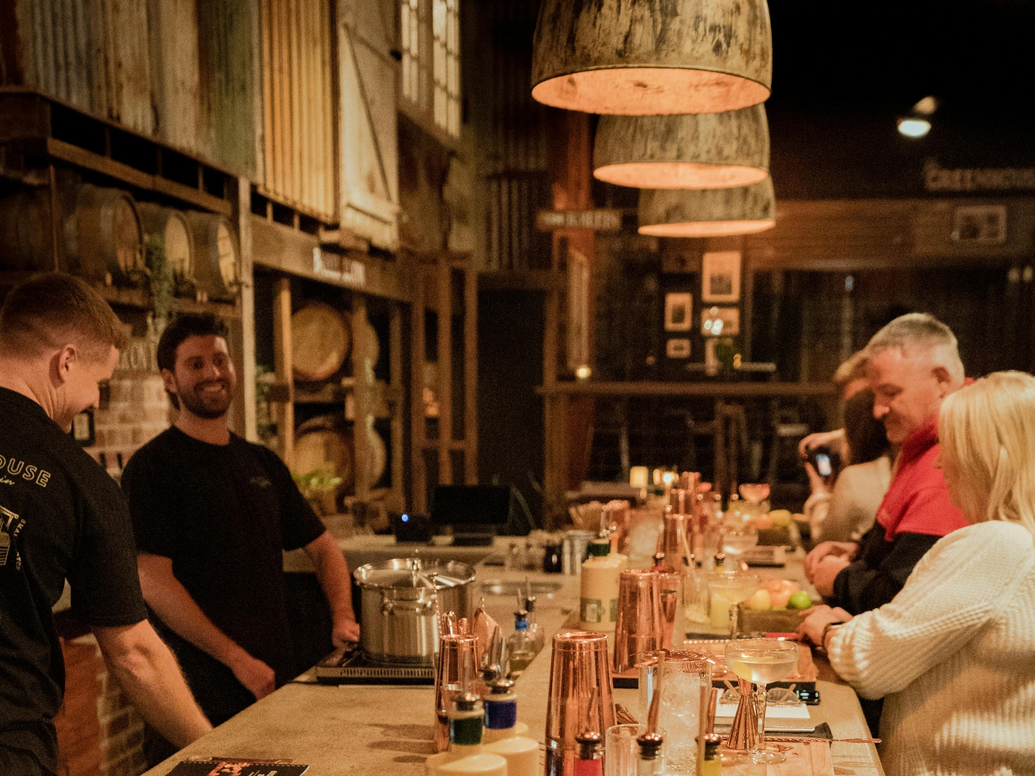 Everyone laughing and enjoying the banter during a cocktail masterclass.