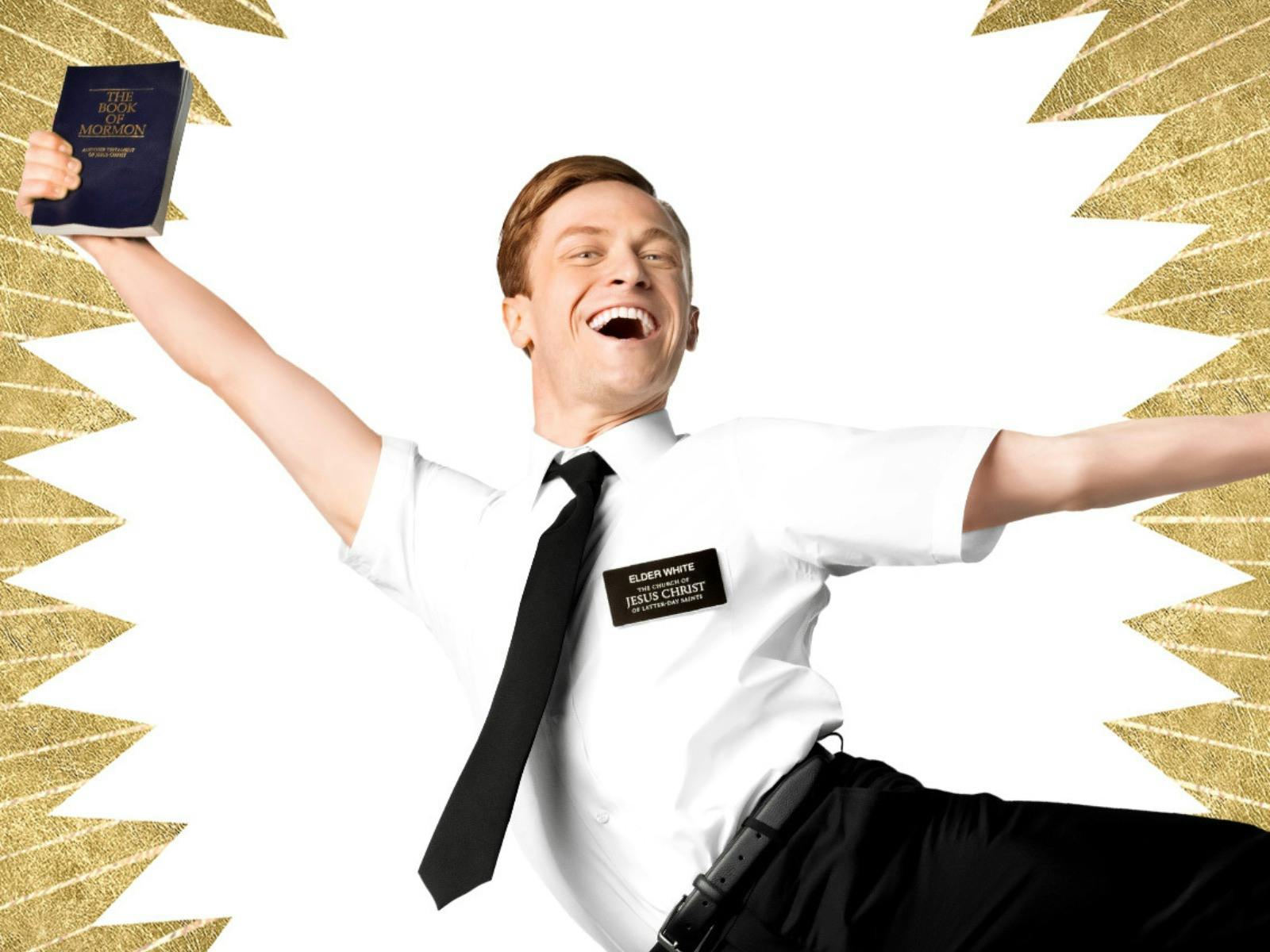A man in a white shirt and black tie leaps holding a book, against a gold sunburst background.