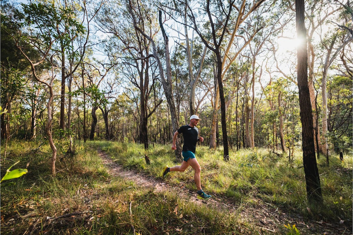 Man running along dirt trail at Bayview Conservation Area, Redlands Coast, Queensland