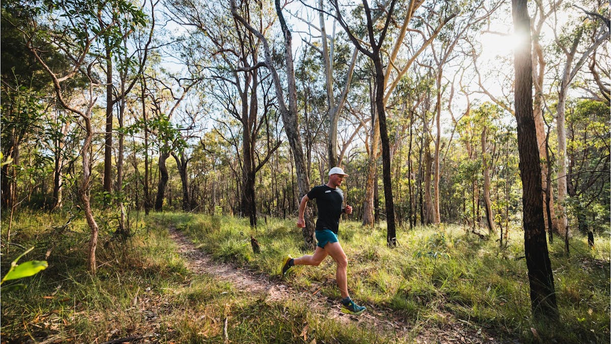 Man running along dirt trail at Bayview Conservation Area, Redlands Coast, Queensland