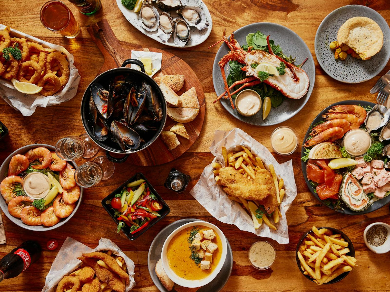 A table displaying a range of seafood dishes including crayfish, oysters, fish & chips and more