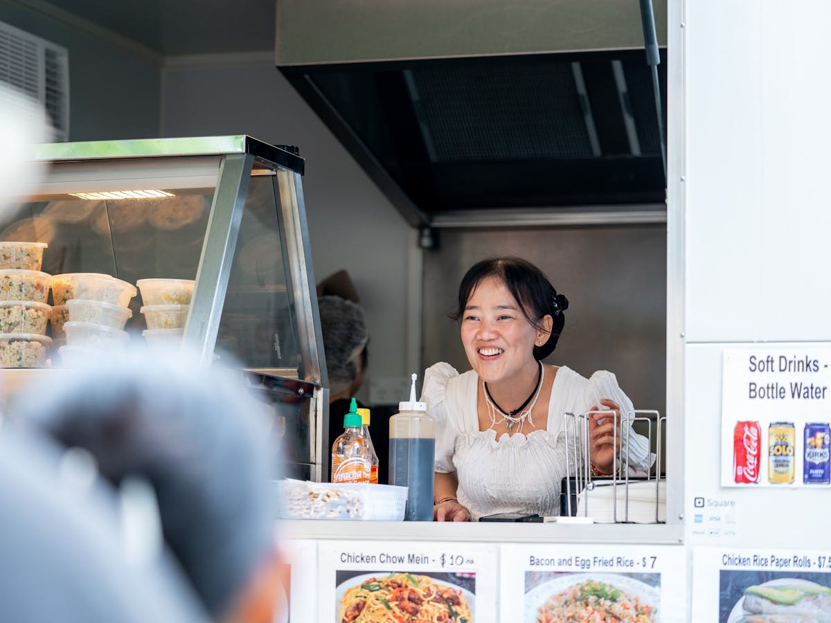 A woman serves customers at her food stall at the Mareeba Multicultural Festival.