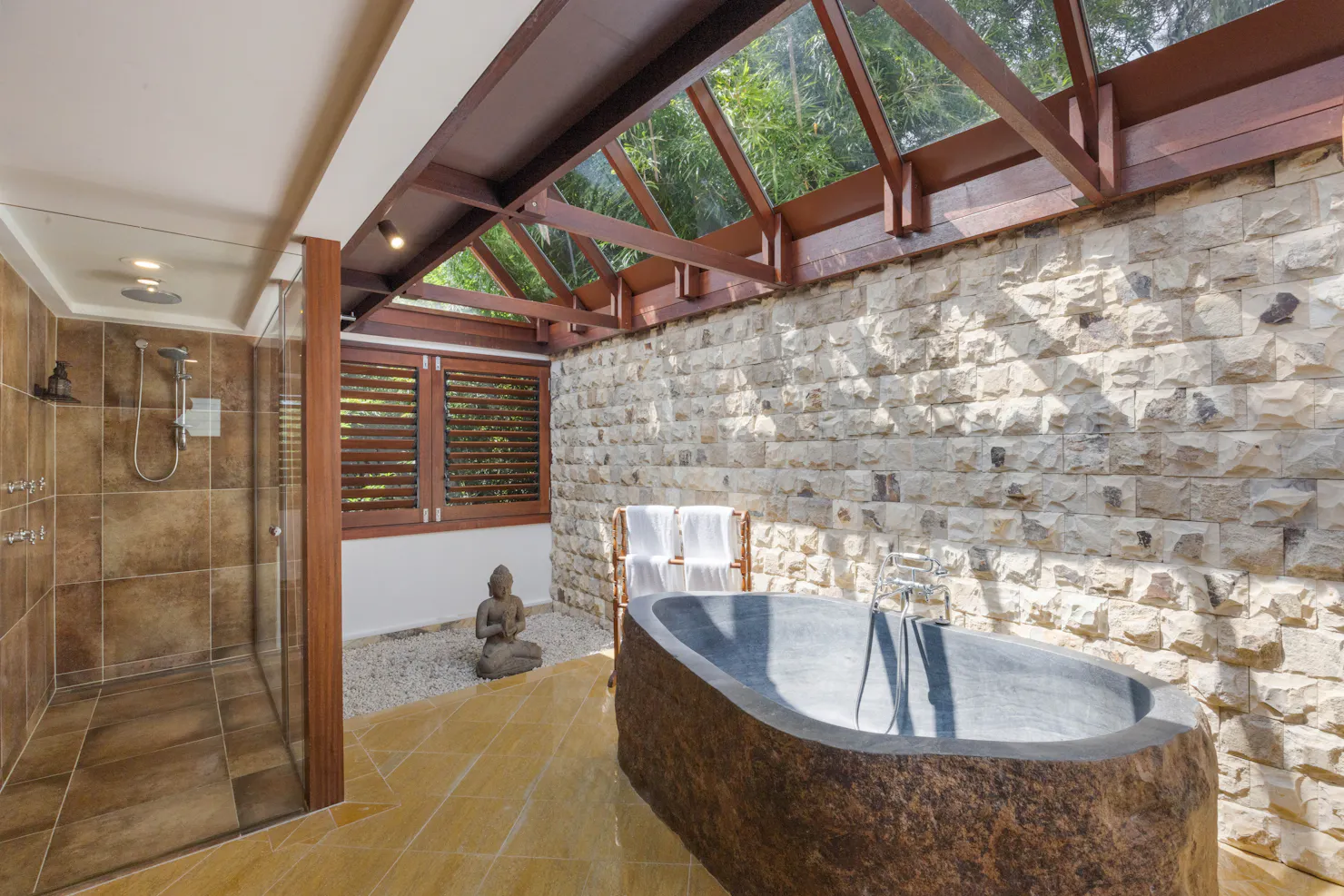 Hand carved, volcanic stone bathtub, under a clear roof